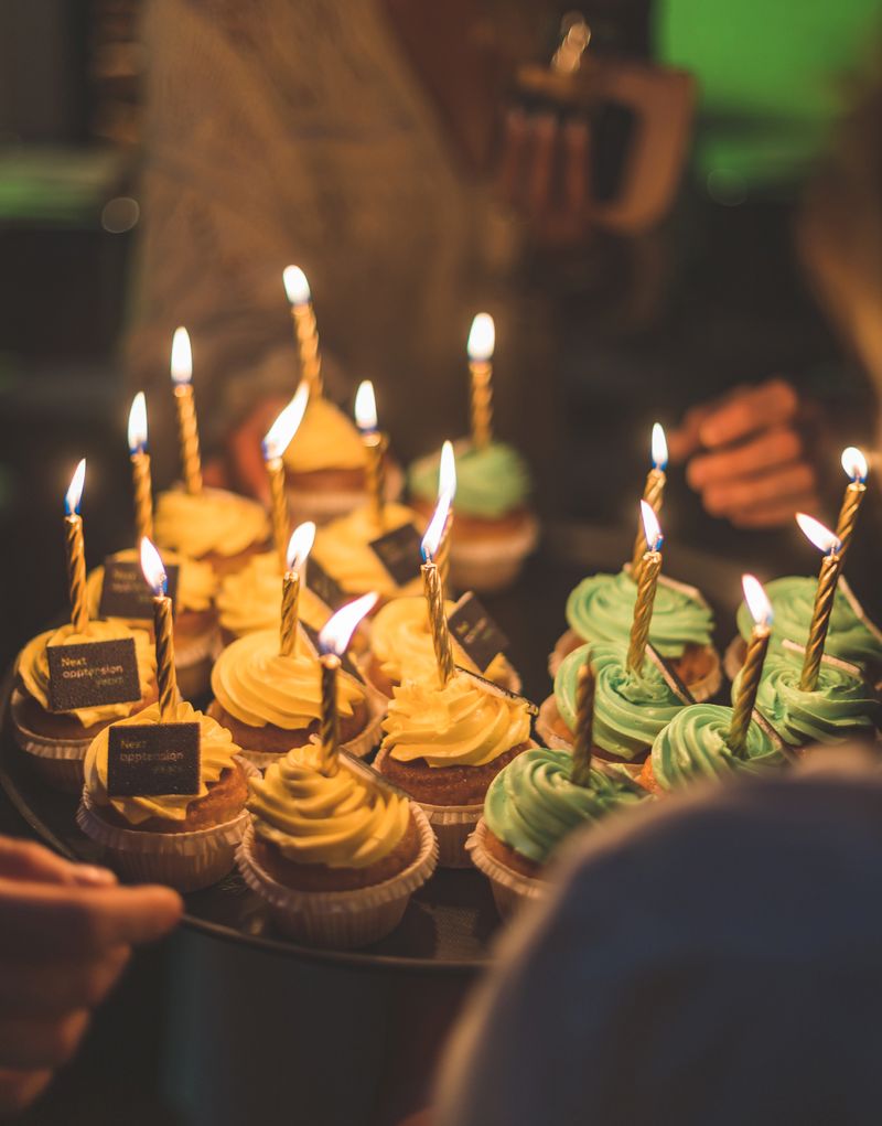 Cupcakes with birthday candles on them that were eaten on Apptension 10th birthday party