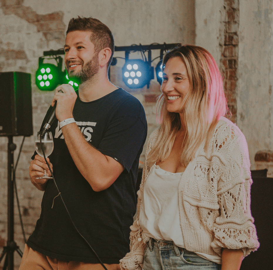 CEO and CPO of Apptension standing together on a stage during an integration event